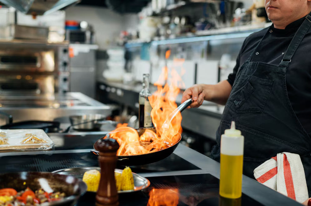 Side View Male Chef Flambeing Dish | Restaurant Equipment For Sale